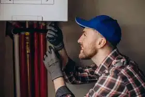 service man adjusting house heating system 1 1